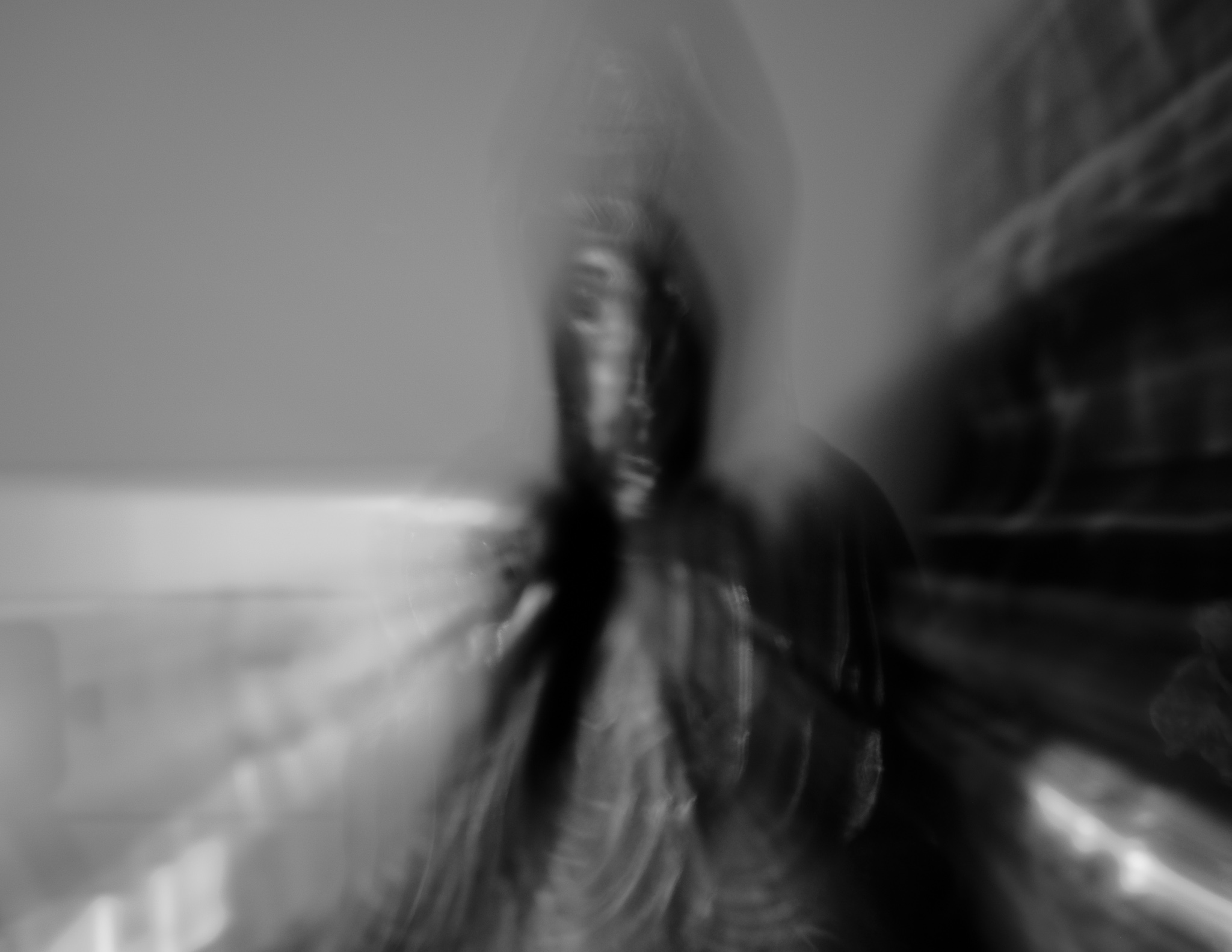 Christian Solorzano — ghostly black-and-white motion-blurred portrait of a figure standing in a room