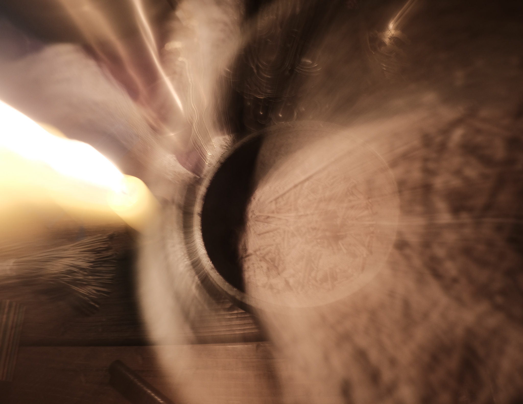 Christian Solorzano — warm-toned abstract photograph of candlelight and hands blurred in motion