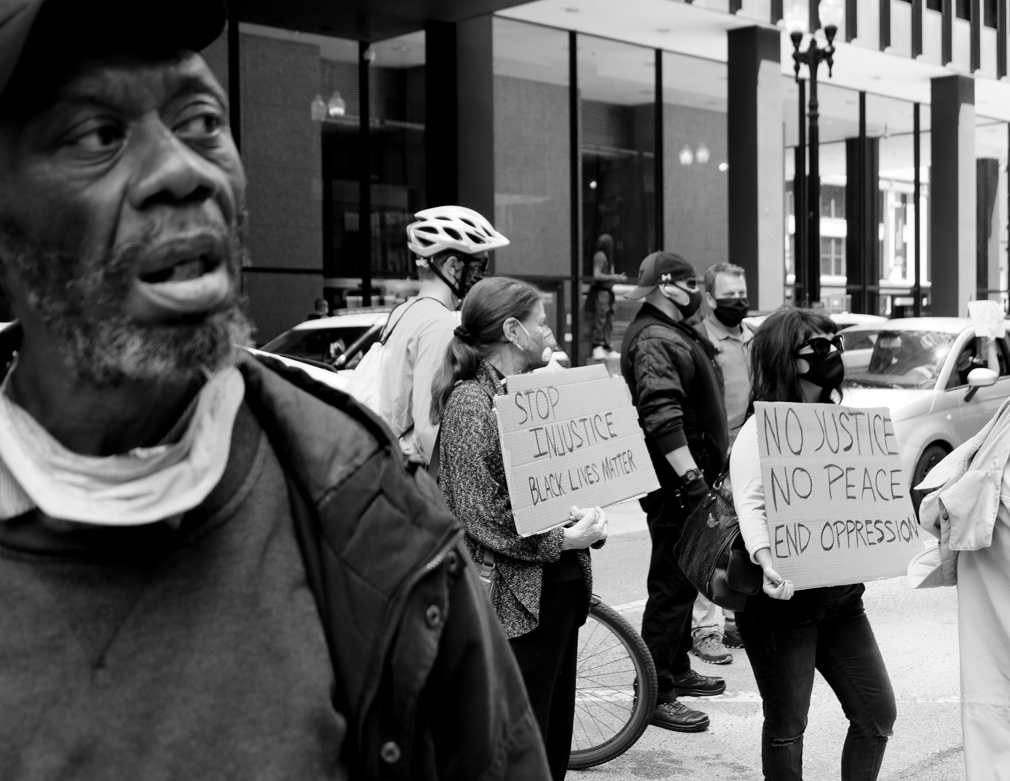 Christian Solorzano — black-and-white street photograph of a Black Lives Matter protest with demonstrators holding signs